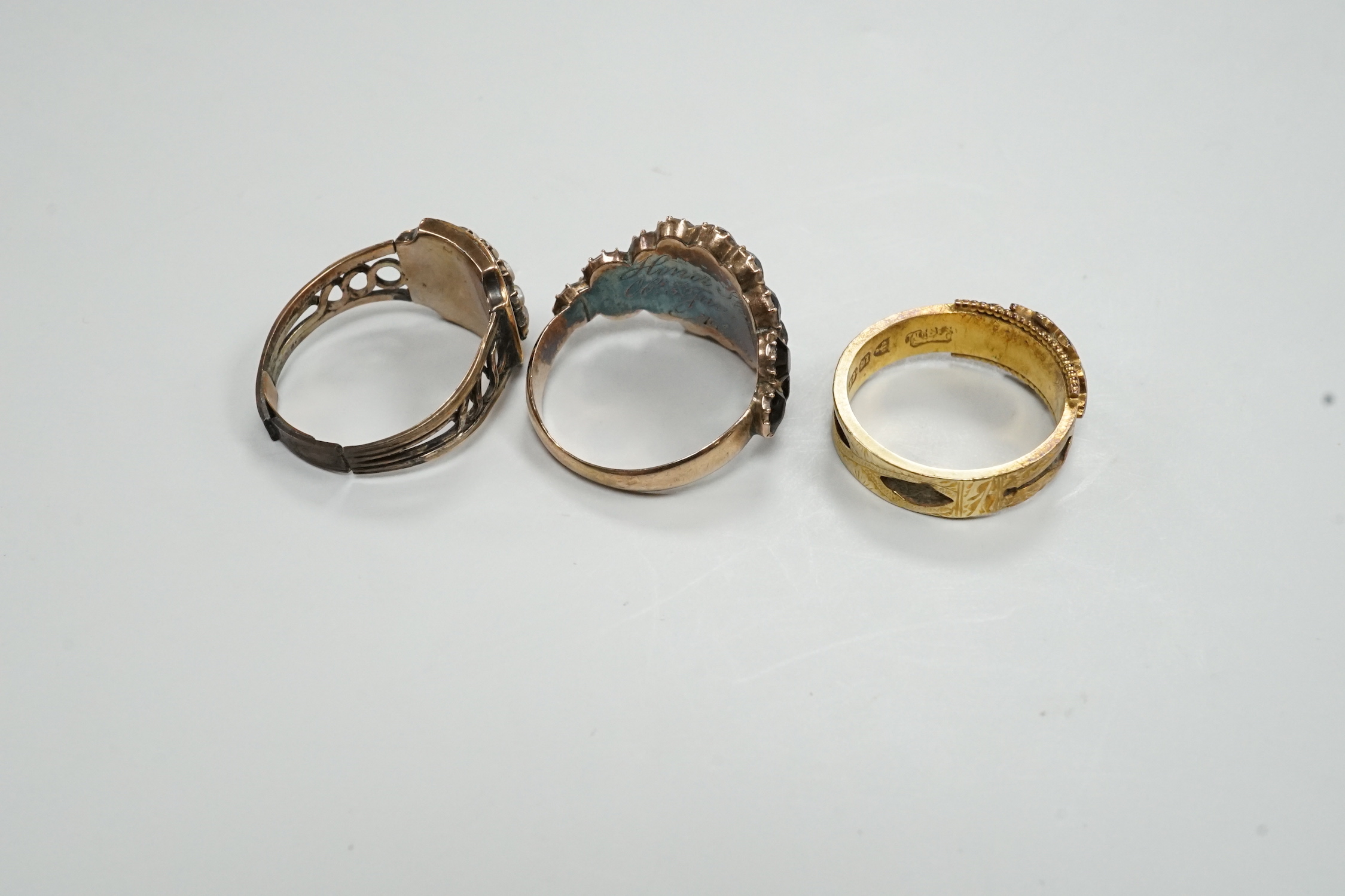 Three assorted Georgian mourning rings, including a 15ct gold, seed pearl and black enamel.